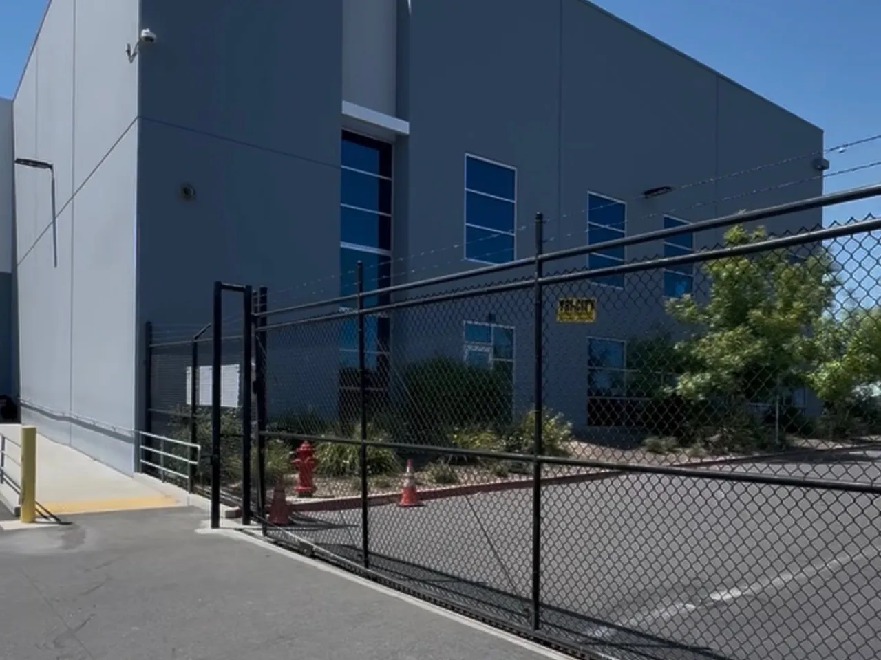 Commercial rolling slide gate at a Sacramento-area business serviced by LMS Garage Doors