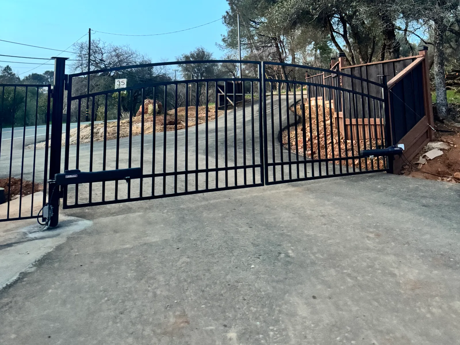 LiftMaster gate operator on a double swing driveway gate serviced by LMS Garage Doors